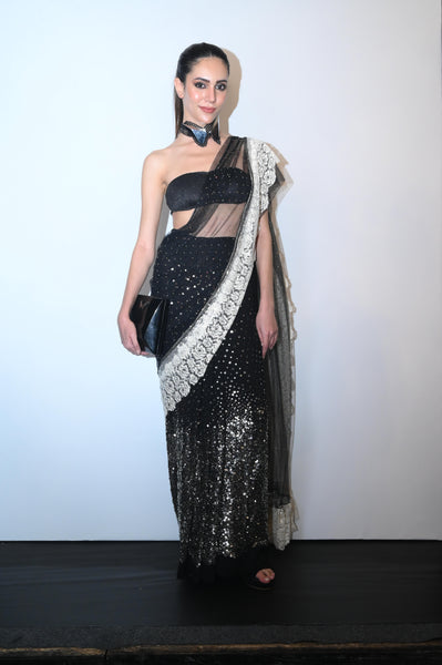 Modern sequined saree with sheer drape and sculpted bandeau blouse.