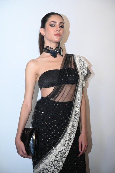 Modern sequined saree with sheer drape and sculpted bandeau blouse.