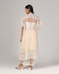 Peach georgette/ net with very fine floral thread work embroidered ,pin tuck white bustier and an overlay with feathers